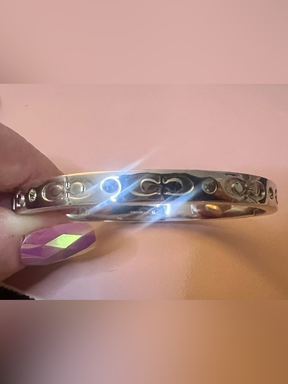 COACH silver bangle bracelet with rhinestone accents